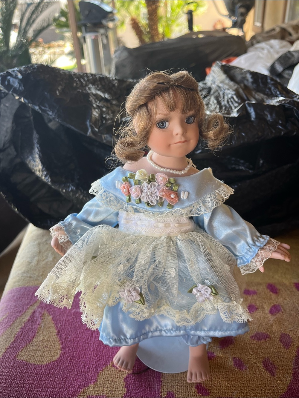 Vintage-Style Porcelain Doll in Light Blue Dress with Floral Accents